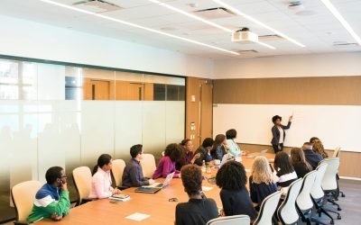 Professional team engaged in a collaborative boardroom meeting with a presentation in progress.